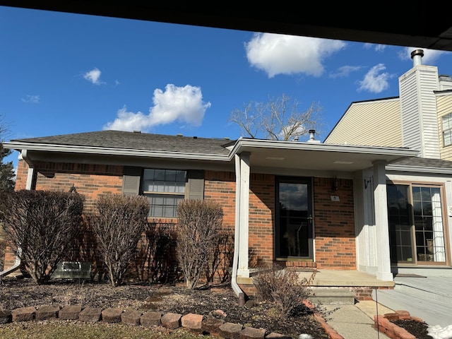 exterior space with brick siding