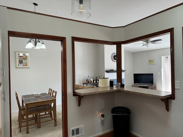 kitchen with visible vents, carpet floors, ceiling fan, pendant lighting, and open floor plan