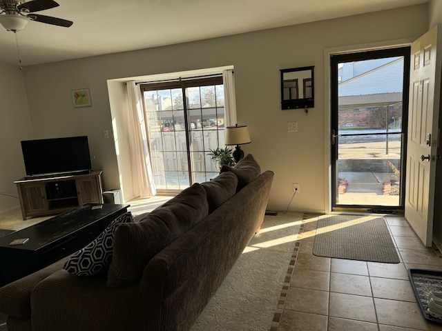 tiled living area with a ceiling fan