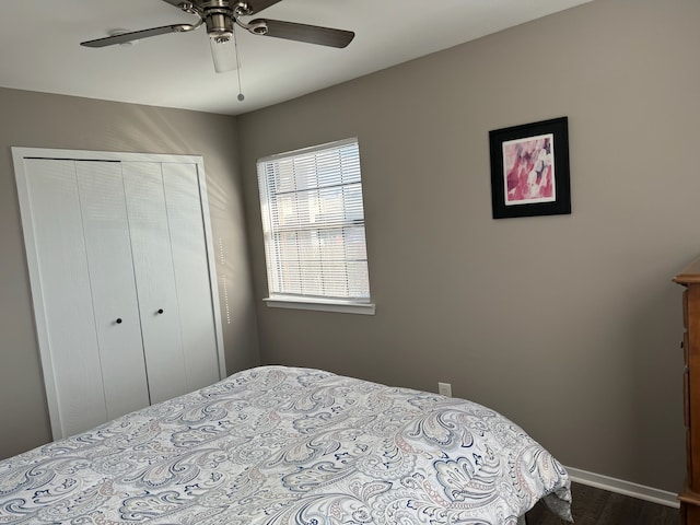 bedroom with a closet, baseboards, and ceiling fan