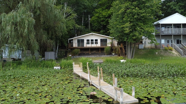 view of front of home with stairway and a deck