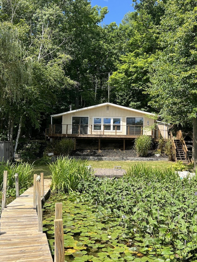 rear view of house with a wooden deck and stairs