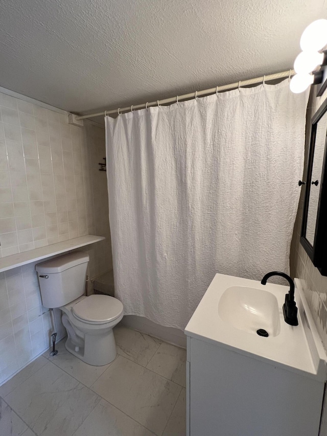 full bath with toilet, a shower with shower curtain, vanity, marble finish floor, and a textured ceiling