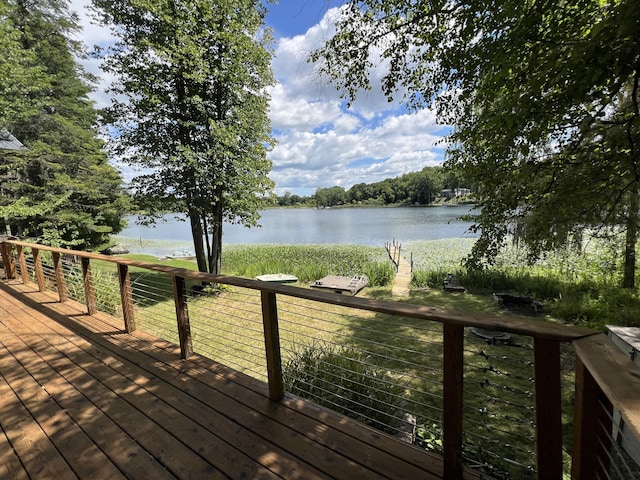 wooden terrace featuring a water view