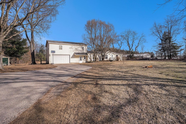 view of property exterior with aphalt driveway and a garage