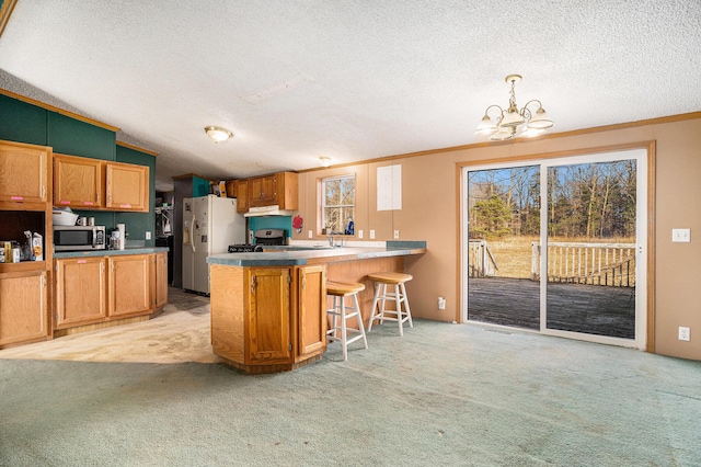 kitchen featuring light carpet, stainless steel microwave, white refrigerator with ice dispenser, a peninsula, and lofted ceiling