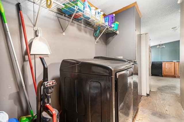 washroom with washer and dryer, laundry area, and a textured ceiling