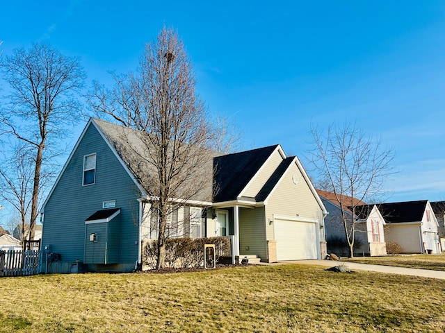 view of front of home with a garage, concrete driveway, a front yard, and fence