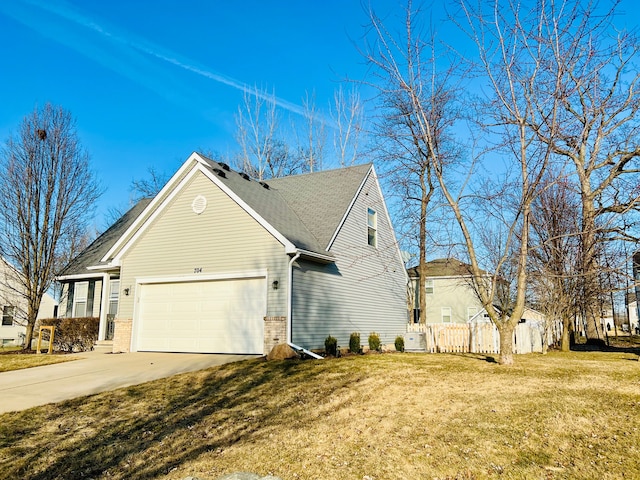 view of home's exterior featuring brick siding, fence, a garage, a yard, and driveway