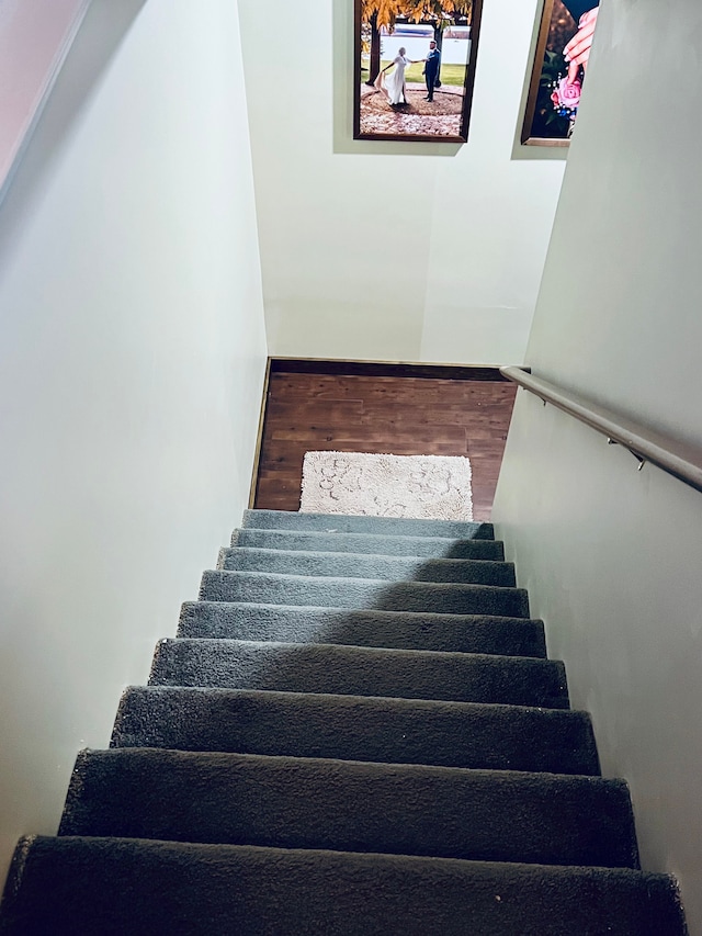 stairway featuring wood finished floors