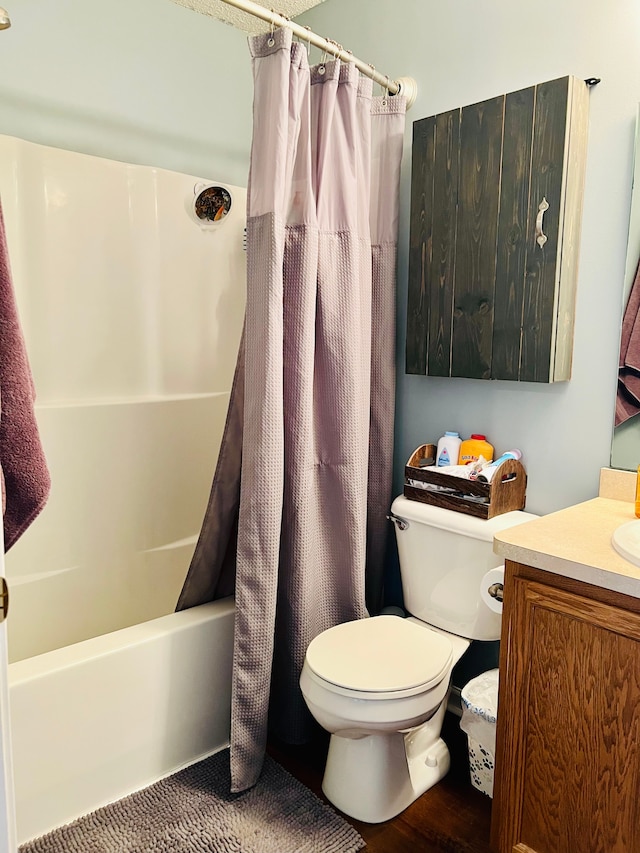 bathroom featuring toilet, vanity, and shower / bathtub combination with curtain