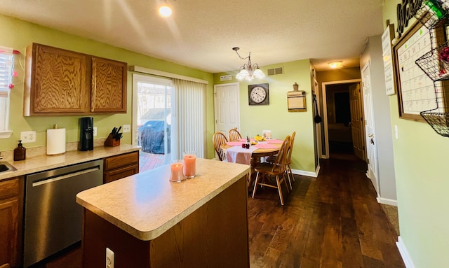 kitchen featuring dishwasher, light countertops, visible vents, and brown cabinets