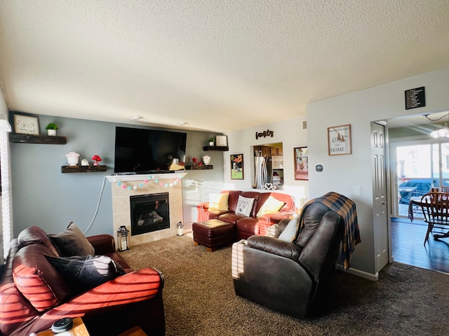 carpeted living room featuring a fireplace and a textured ceiling