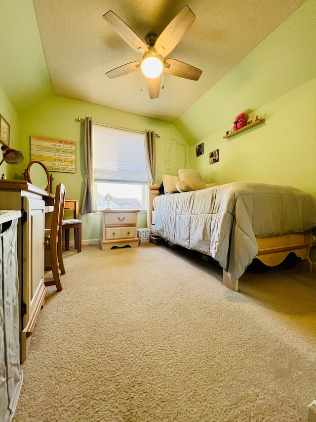 bedroom with a textured ceiling, carpet flooring, baseboards, ceiling fan, and vaulted ceiling