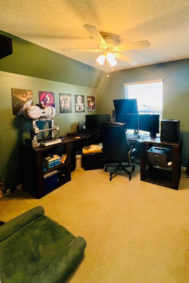 carpeted home office with a textured ceiling and a ceiling fan