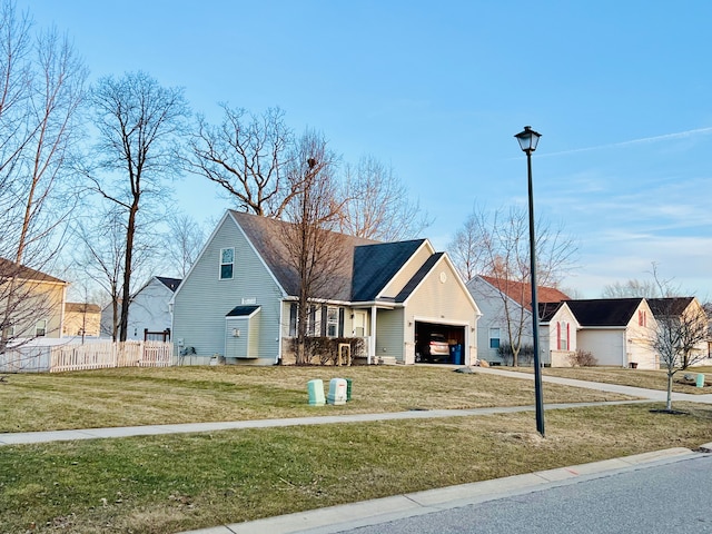 bungalow-style house featuring a garage, a front yard, and fence