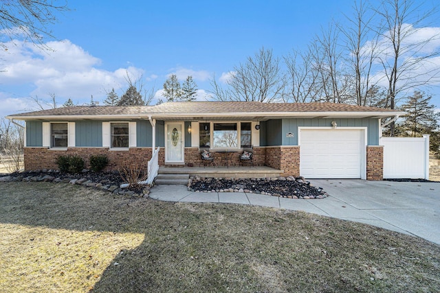 single story home with fence, driveway, a porch, a garage, and brick siding