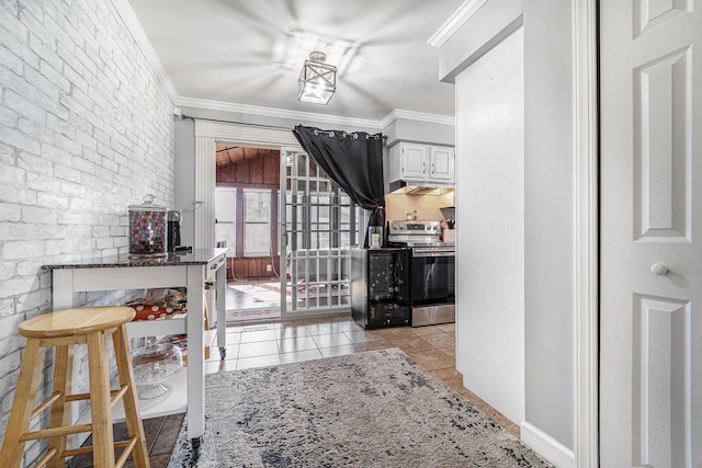 interior space featuring light tile patterned floors, brick wall, and ornamental molding