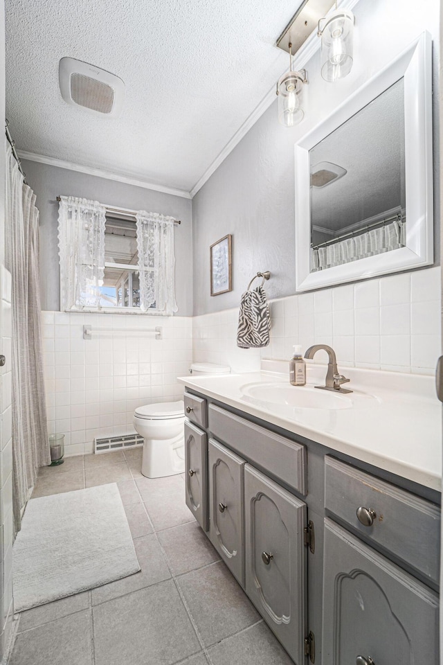 full bathroom with vanity, crown molding, a textured ceiling, tile walls, and toilet