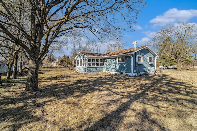 rear view of property with a sunroom