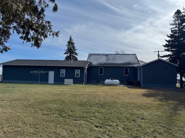 rear view of property with a yard