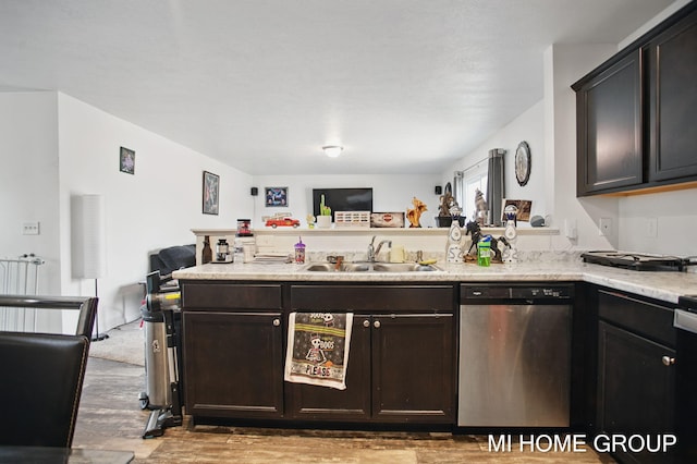 kitchen featuring dark brown cabinets, dishwasher, light countertops, a peninsula, and a sink