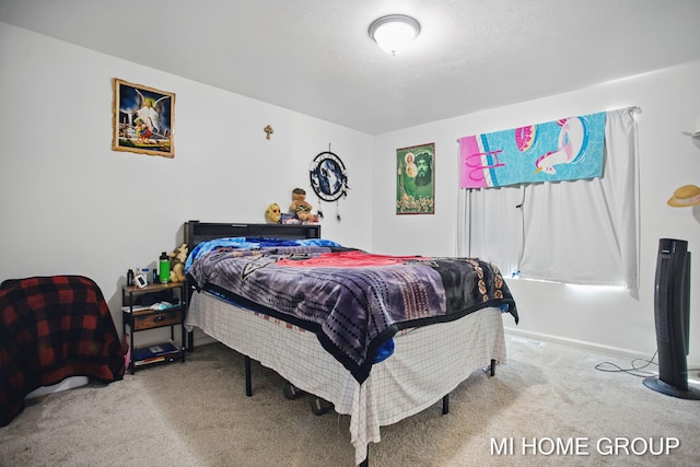 carpeted bedroom featuring baseboards