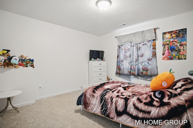 carpeted bedroom featuring visible vents, a textured ceiling, and baseboards