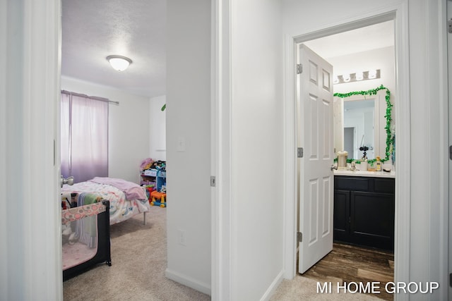 hall with baseboards and carpet