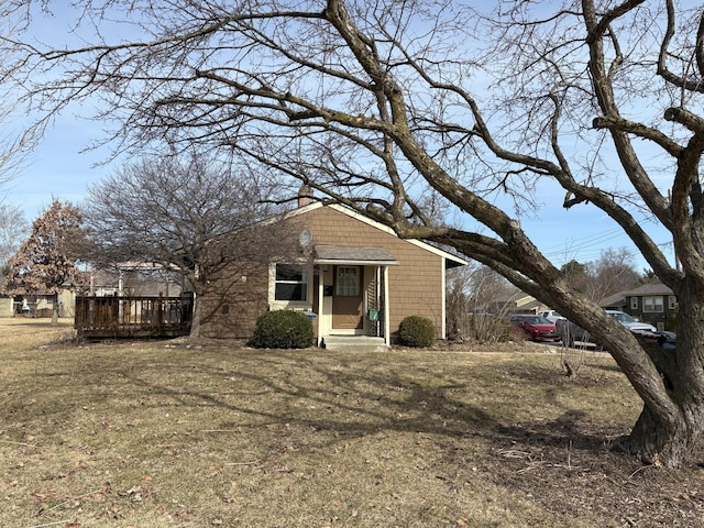 view of front of property featuring a wooden deck and a chimney