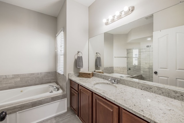 bathroom with a bath, visible vents, a shower stall, and vanity