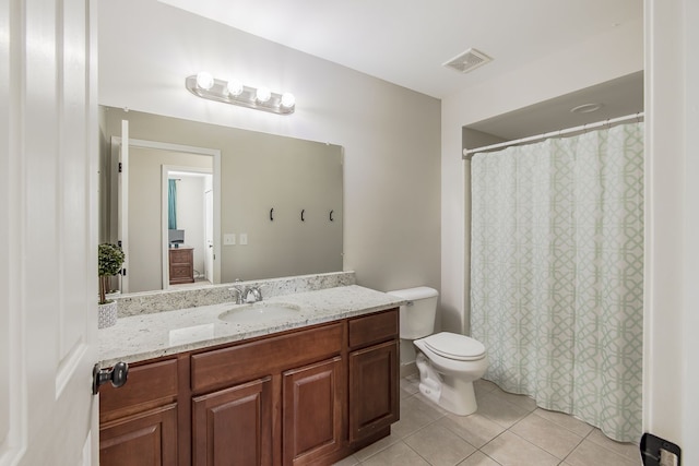 bathroom featuring visible vents, toilet, a shower with shower curtain, tile patterned floors, and vanity