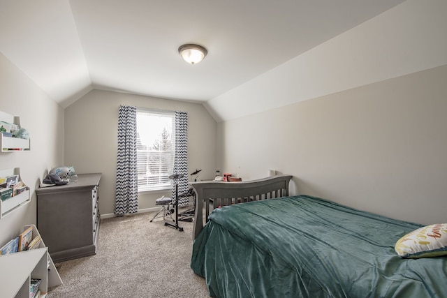 bedroom featuring baseboards, lofted ceiling, and light colored carpet