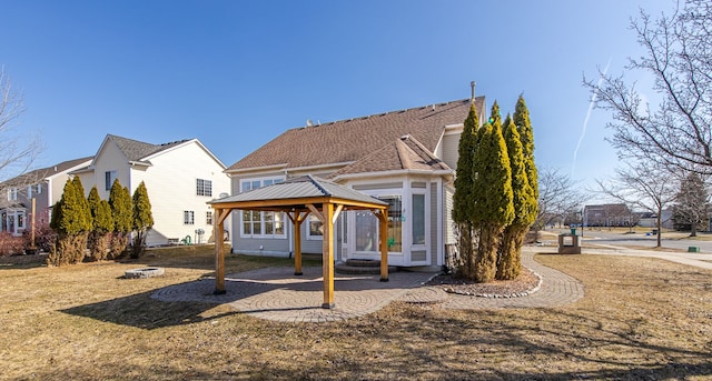 rear view of property featuring a gazebo