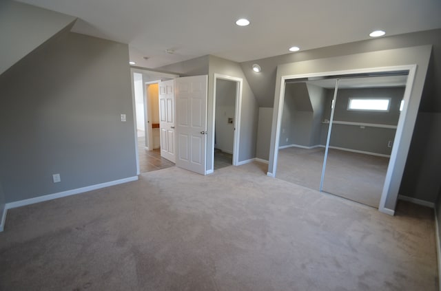 unfurnished bedroom featuring recessed lighting, a closet, baseboards, and carpet flooring