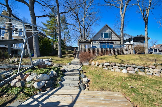 exterior space featuring a deck and a lawn