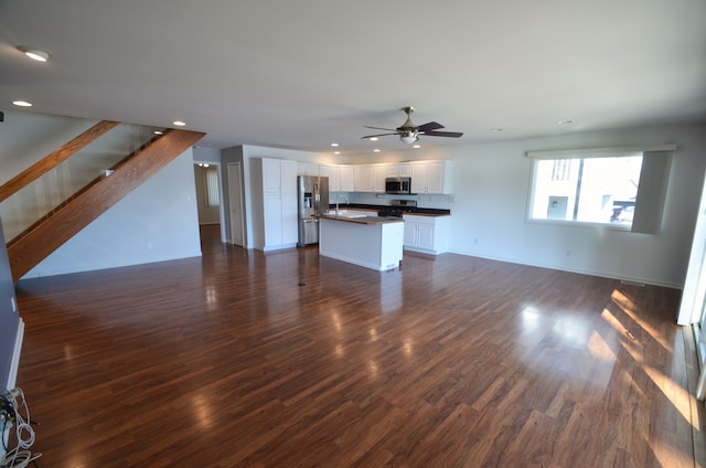 unfurnished living room with a sink, recessed lighting, dark wood-style floors, and a ceiling fan