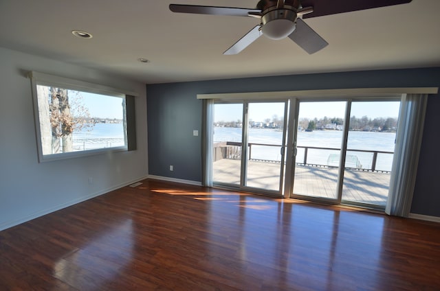 unfurnished room with a wealth of natural light and wood finished floors