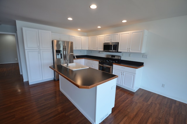 kitchen featuring a sink, dark countertops, dark wood-style flooring, and stainless steel appliances