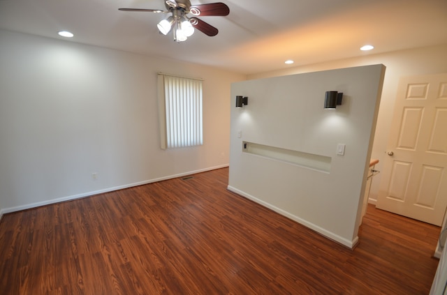 spare room with recessed lighting, wood finished floors, and baseboards