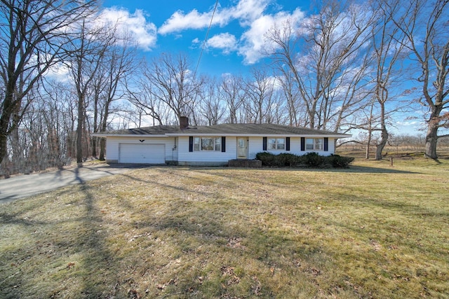 ranch-style home with a front lawn, an attached garage, a chimney, and driveway