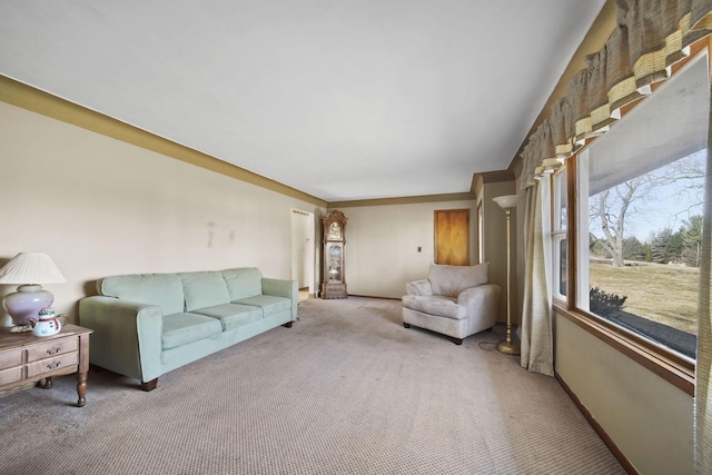 living area featuring light carpet and baseboards