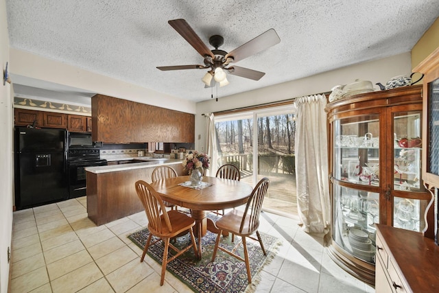 dining area featuring light tile patterned floors, a textured ceiling, and a ceiling fan