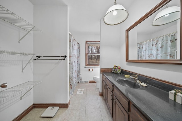 full bathroom with tile patterned floors, toilet, vanity, and baseboards