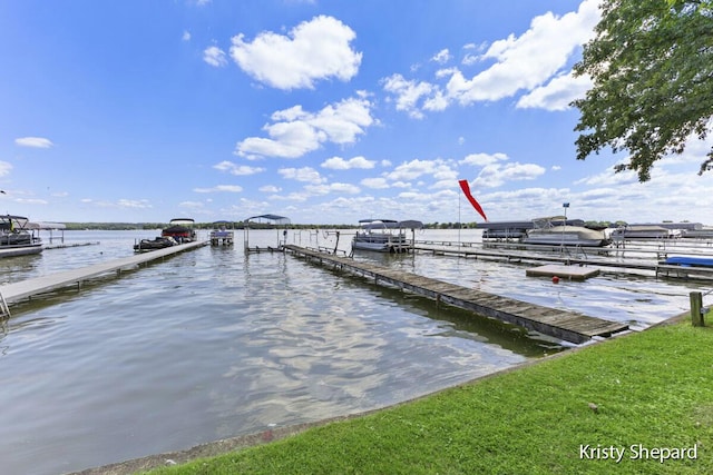 view of dock with boat lift and a water view