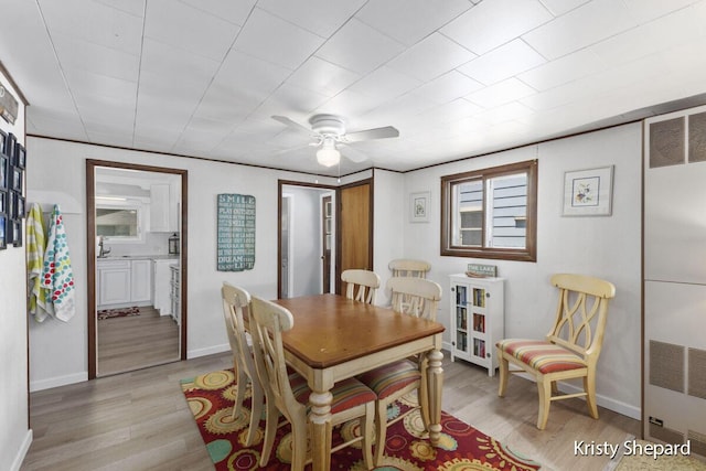 dining space featuring visible vents, baseboards, ceiling fan, and light wood finished floors