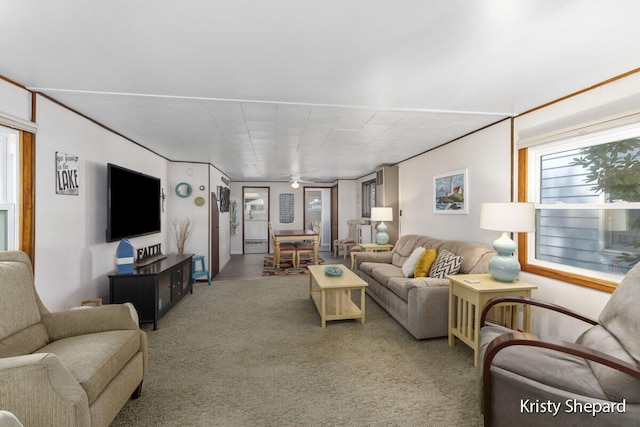 carpeted living room featuring ceiling fan