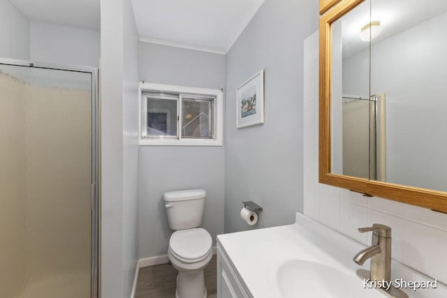 full bath with vanity, wood finished floors, a stall shower, decorative backsplash, and toilet