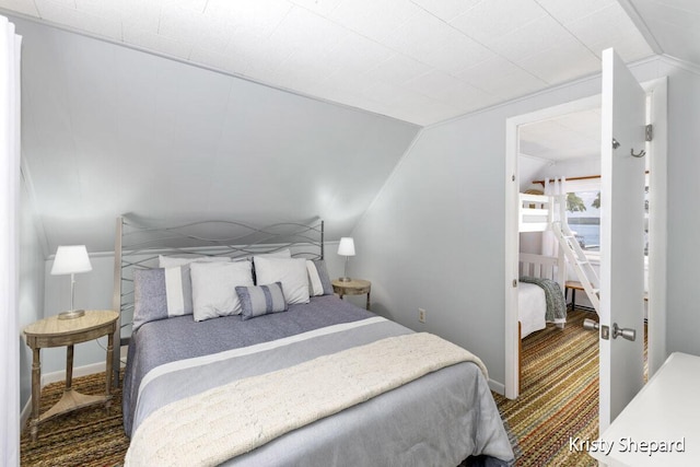 bedroom with carpet and vaulted ceiling