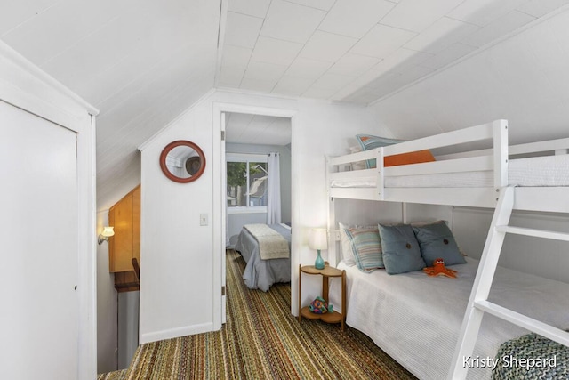 bedroom featuring lofted ceiling and carpet floors